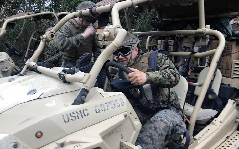 A member of the 3rd Battalion, 4th Marine Regiment starts up a vehicle loaded with communications gear during an exercise at Camp Schwab, Okinawa, Feb. 14, 2023. 