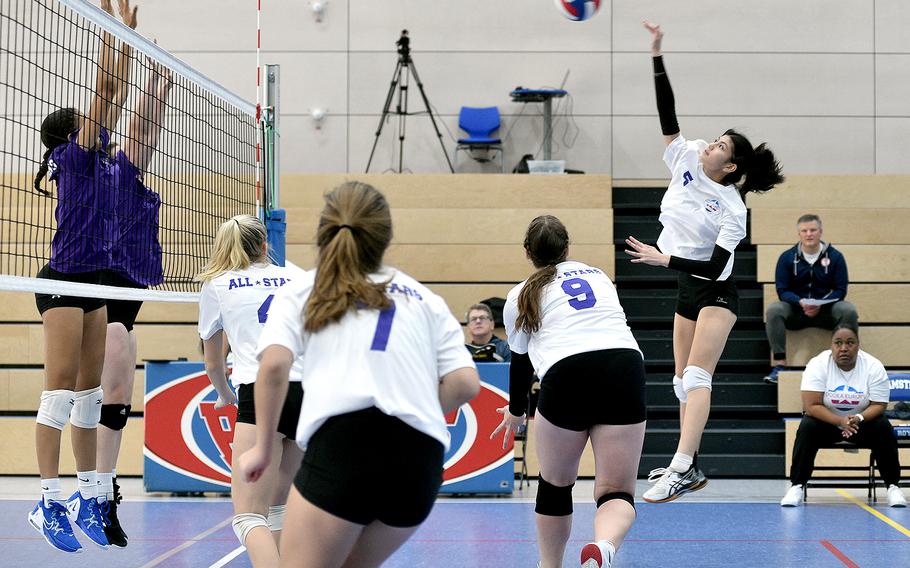Ramstein’s Sophia Schluth, right, spikes the ball Saturday during a DODEA-Europe all-star volleyball match at Ramstein High School on Ramstein Air Base, Germany. Team White teammates, from left, Elizabeth Troxel of Wiesbaden, Madison Bell of Vilseck and Kennedy Kohrs of Ansbach move into position.