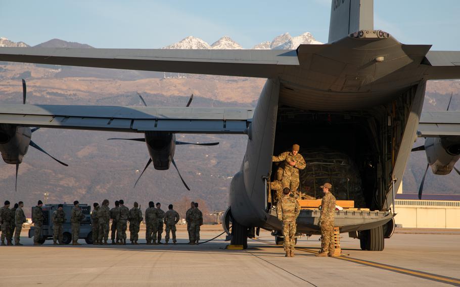Soldiers wait to board a cargo plane at Aviano Air Base, Italy, Feb. 24, 2022. Soldiers of the 173rd Airborne Brigade's 2nd Battalion, 503rd Infantry Regiment departed Italy for Latvia as part of the NATO response to Russia's invasion of Ukraine.