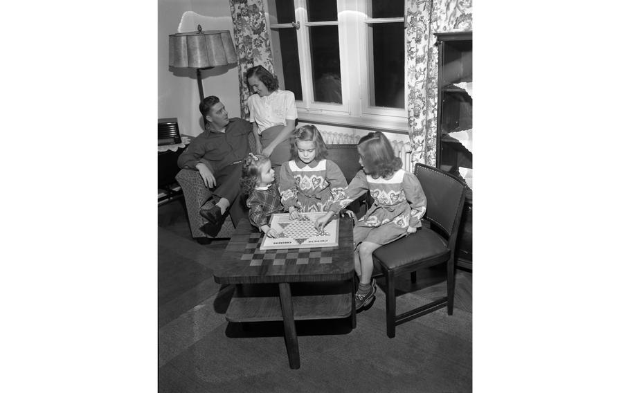 M. Sgt. William F. Garland, of Hq Co., 18th Inf., his wife, Helen, and their three daughters, Glenda Lee, 7, Billie Joe, 6, and Sandra Elizabeth, 3, in their living room, one of the 156 newly constructed apartment units for service members and their families in Aschaffenburg.