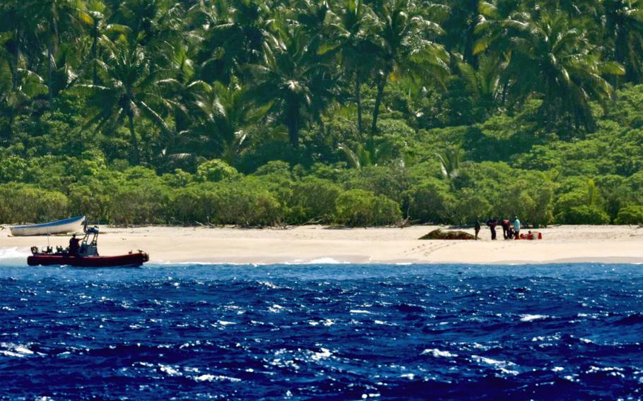 The crew of the U.S. Coast Guard cutter Oliver Henry makes contact with three mariners stranded on Pikelot Atoll, Yap State, Federated States of Micronesia, on April 9, 2024.