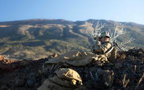 A member of the 3rd Marine Division observes his fire sectors during an Army-led exercise at Pohakuloa Training Area, Hawaii, in November 2023.