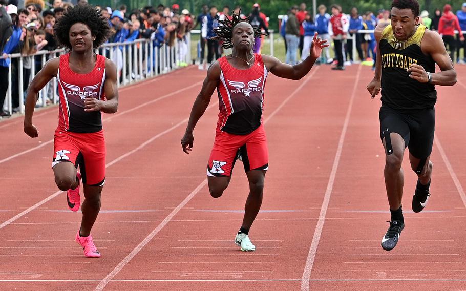 Kaiserslautern’s Brelan Barnes, left, won the boys 100-meter dash at the DODEA-Europe track and field championships in Kaiserslautern, Germany, May 20, 2023, In a close race, he beat Stuttgart’s Alex Guthrie by .02 seconds, winning in 11.17 seconds. At center is Davis Martin who was fifth.