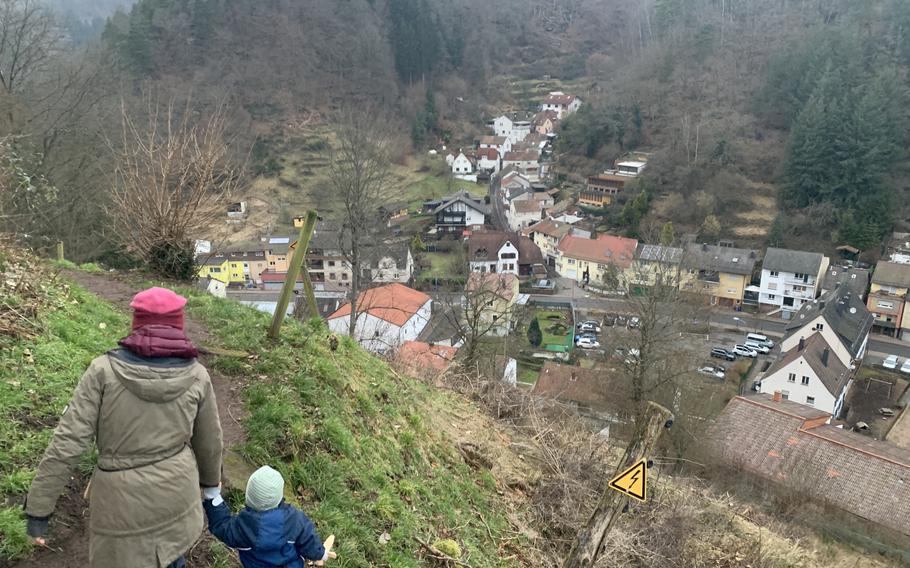 A child wielding a wooden sword prepares to venture down a path from the Frankenstein Castle ruins into the town below, Sunday, Jan. 23, 2022.