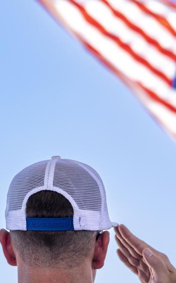 A man salutes the American flag