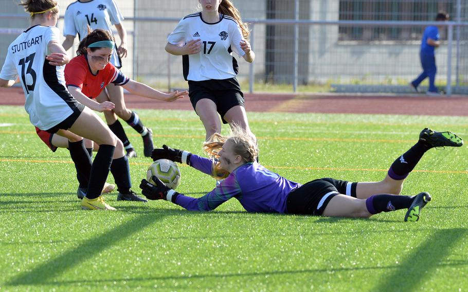 Lakenheath keeper Chloe Aldrich stretches to reel in the ball in front of Stuttgart’s Ella Engelke, left, Haley Wells, right and teammate Alyssa Salina, in the girls Division I final at the DODEA-Europe soccer championships in Ramstein, Germany, May 18, 2023. Stuttgart beat Lakenheath 1-0 to win the title 