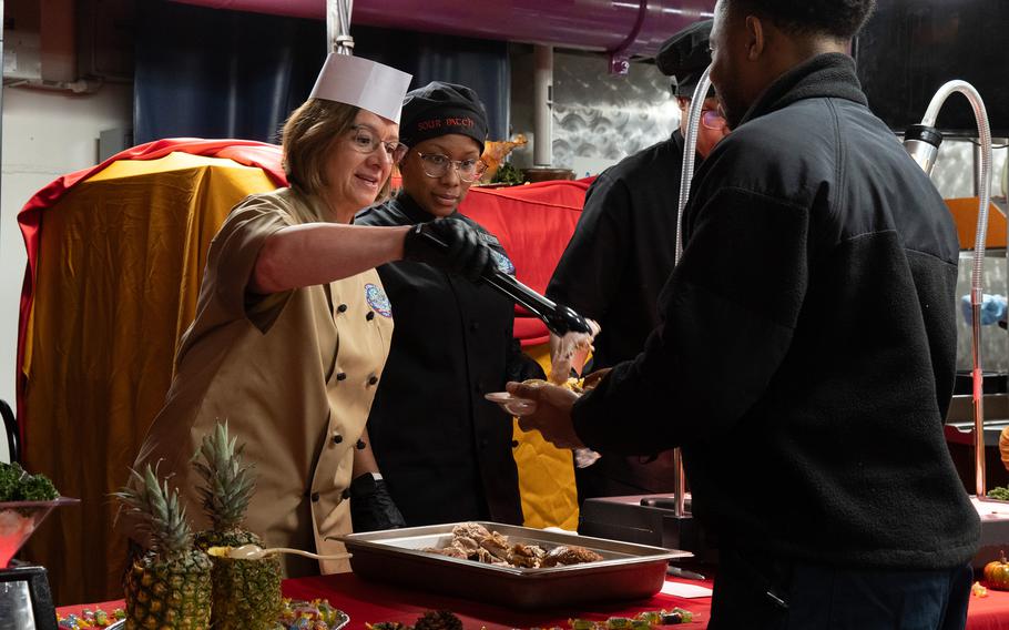 Chief of Naval Operations Adm. Lisa Franchetti helps serve a Thanksgiving meal aboard the USS Ronald Reagan at Yokosuka Naval Base, Japan, Thursday, Nov. 23, 2023.