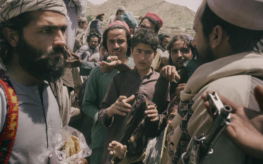 Taliban militants distribute bread in Paktika province. 