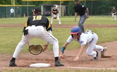 Ramstein sophomore Conor McGinty dives back to first base during the Division I DODEA European baseball championship game against Stuttgart on May 20, 2023, at Southside Fitness Center on Ramstein Air Base, Germany. Waiting for the throw is Panther third baseman Josh Zipperer.
