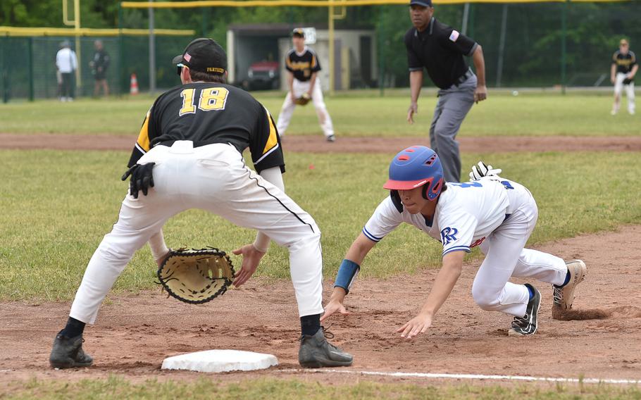 Ramstein sophomore Conor McGinty dives back to first base during the Division I DODEA European baseball championship game against Stuttgart on May 20, 2023, at Southside Fitness Center on Ramstein Air Base, Germany. Waiting for the throw is Panther third baseman Josh Zipperer.