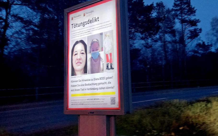 A poster on Merkurstrasse in Kaiserslautern carries photos and information about Diana Bodi, who was found dead in Kaiserslautern on Dec. 14, 2020. Kaiserslautern police on July 22, 2021, released security camera footage showing a man pulling a shopping cart with a large object wrapped in white, past a downtown Kaiserslautern parking garage near the alley where Bodi was found.  