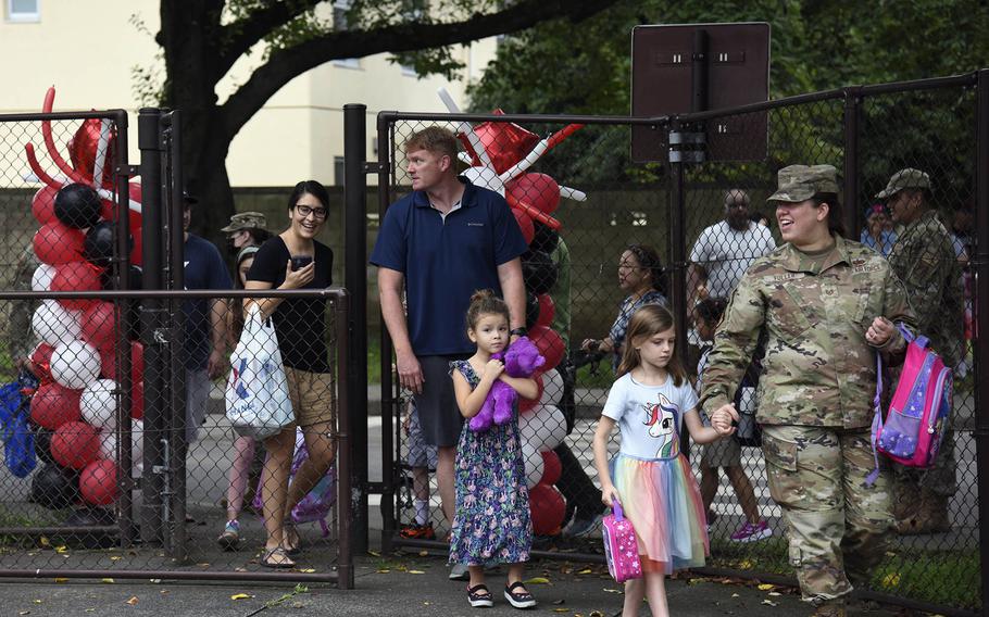 Students and their parents arrive for the first day of classes at Joan K. Mendel Elementary School on Yokota Air Base, Japan, Monday, Aug. 22, 2022.