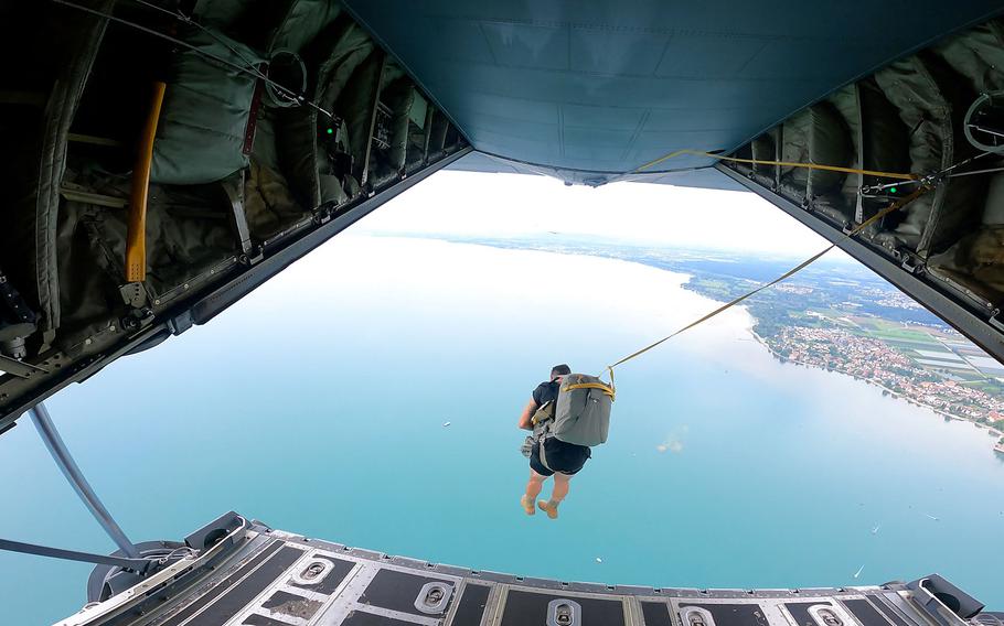 A U.S. Army paratrooper from the 173rd Brigade Support Battalion, 173rd Airborne Brigade, exits a C-130 aircraft during a jump onto Lake Constance, Germany, Friday, July 29, 2022.