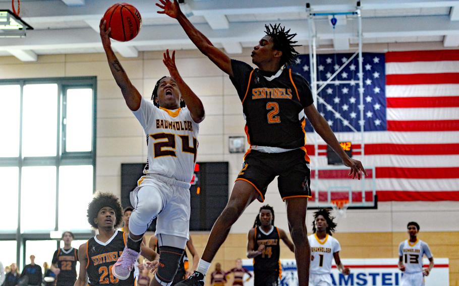 Baumholder’s Johnathan Kimuli takes it to the hoop against Spangdahlem’s Makario Drummond in the Division III championship game at the DODEA-Europe basketball finals in Ramstein, Germany, Feb. 18, 2023. Baumholder took the title with a 40-27 win. 