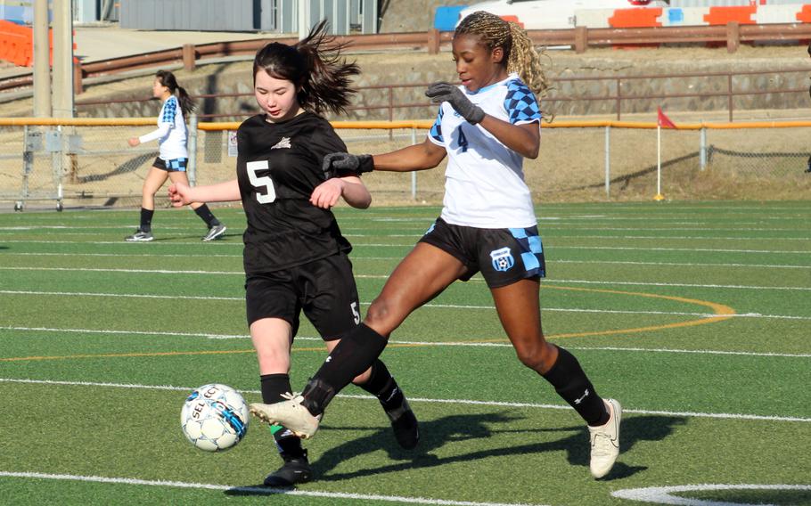 Osan’s Tatiana Lunn pushes the ball upfield against Daegu’s Leilani Rice during Friday’s Korea girls soccer match. The Cougars won 5-2.