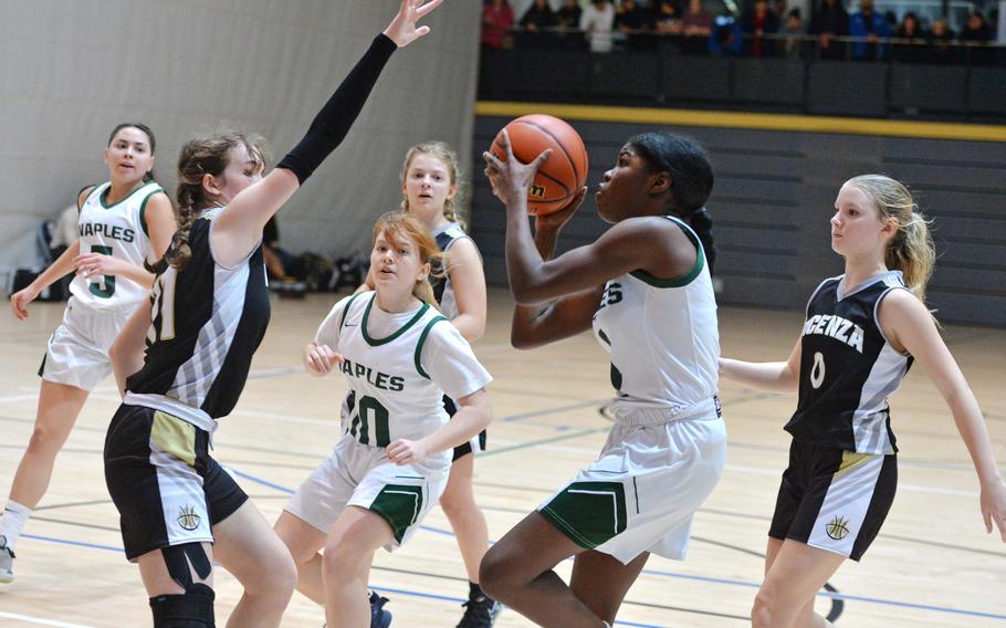 Naples’ Vanae Filer aims for the basket against Vicenza’s Laurel Gill in a Division II semifinal at the DODEA-Europe basketball championships in Ramstein, Germany, Feb. 17, 2023. The Wildcats beat the Cougars 46-39.