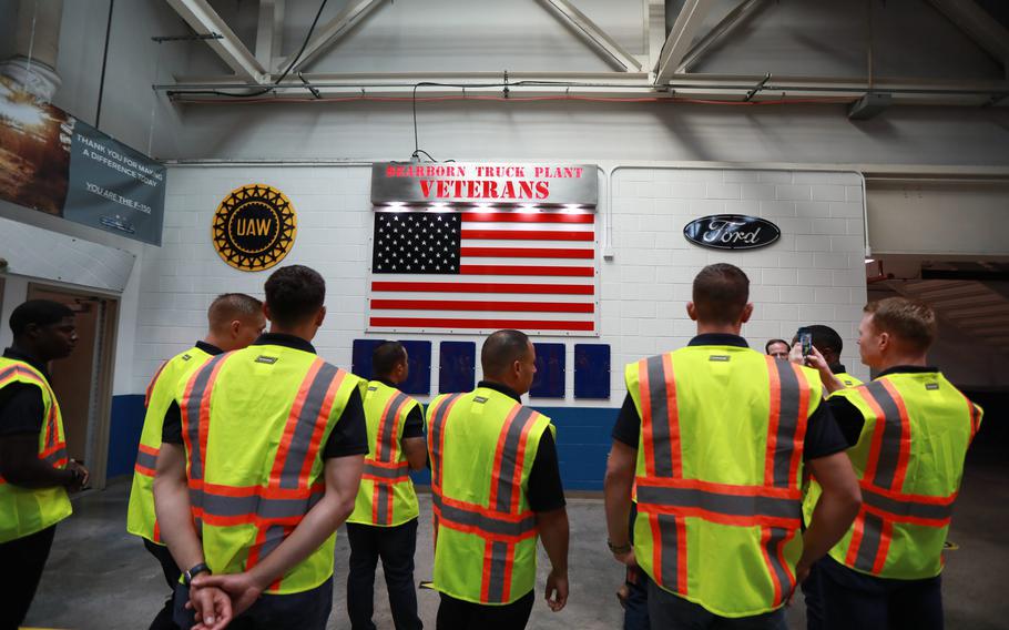 Blue Angels pilots observe the Veterans wall while touring the Dearborn Truck plant assembly line on Aug. 3, 2021.