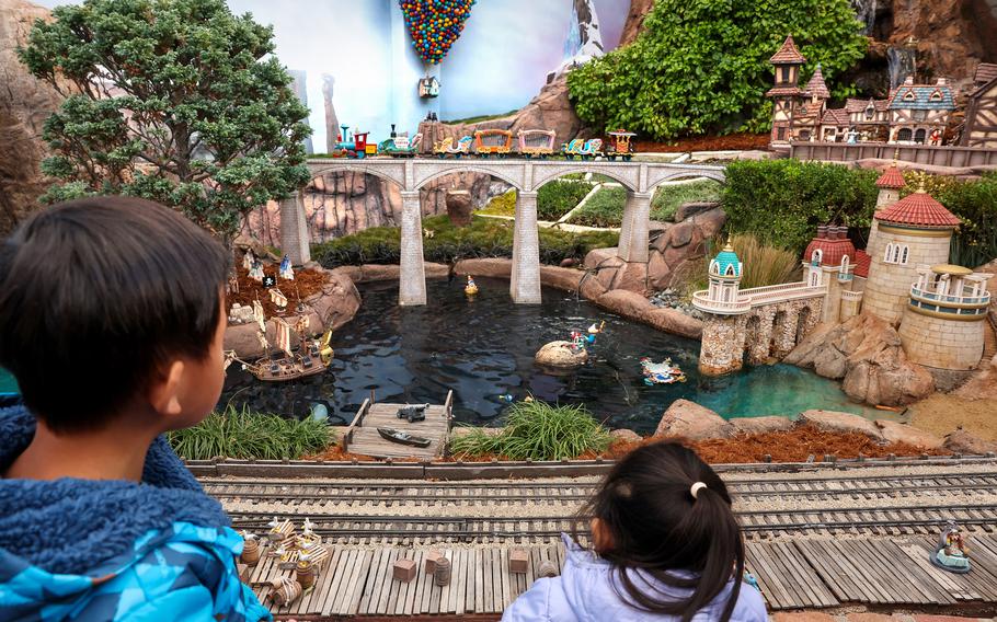 Young visitors look out onto a portion of a railroad and lagoon-like setting within the Sheegogs’ massive attraction.