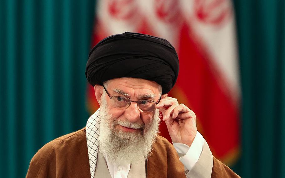 Iran’s Supreme Leader Ayatollah Ali Khamenei adjusts his eyeglasses 