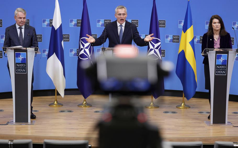 NATO Secretary General Jens Stoltenberg, center, participates in a news conference on Jan. 24, 2022, with Finland’s Foreign Minister Pekka Haavisto, left, and Sweden’s Foreign Minister Ann Linde, right, at NATO headquarters in Brussels. 