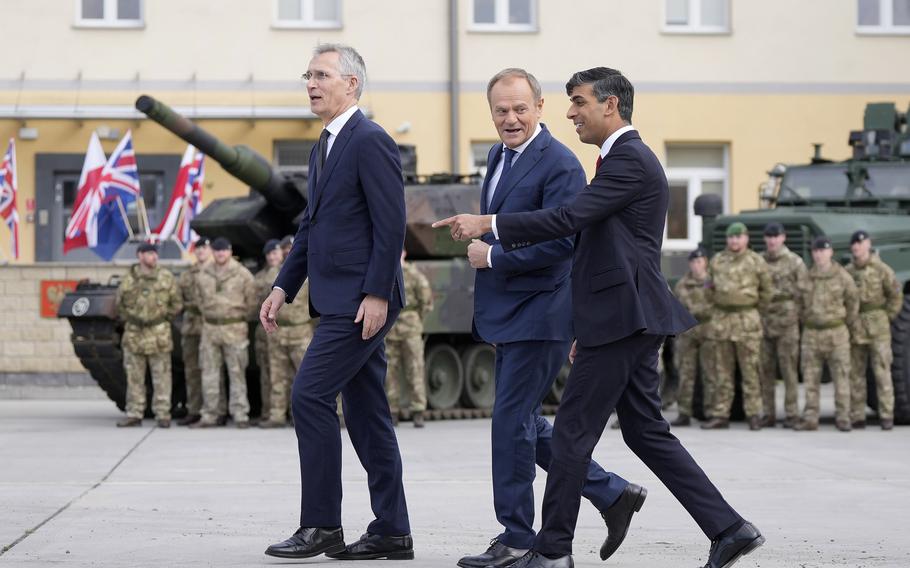 Britain’s Prime Minister Rishi Sunak, right, Poland’s Prime Minister Donald Tusk and NATO Secretary General Jens Stoltenberg, left, arrive together at the Armourd Brigade barracks in Warsaw, Poland, on Tuesday, April 23, 2024.