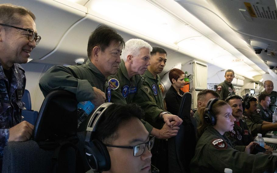 Vice Adm. Karl Thomas, center, commander of the U.S. 7th Fleet, and military leaders from the United States, the Philippines, Australia and Japan fly over the South China Sea in a Navy P-8A Poseidon surveillance plane, Aug. 26, 2023. 