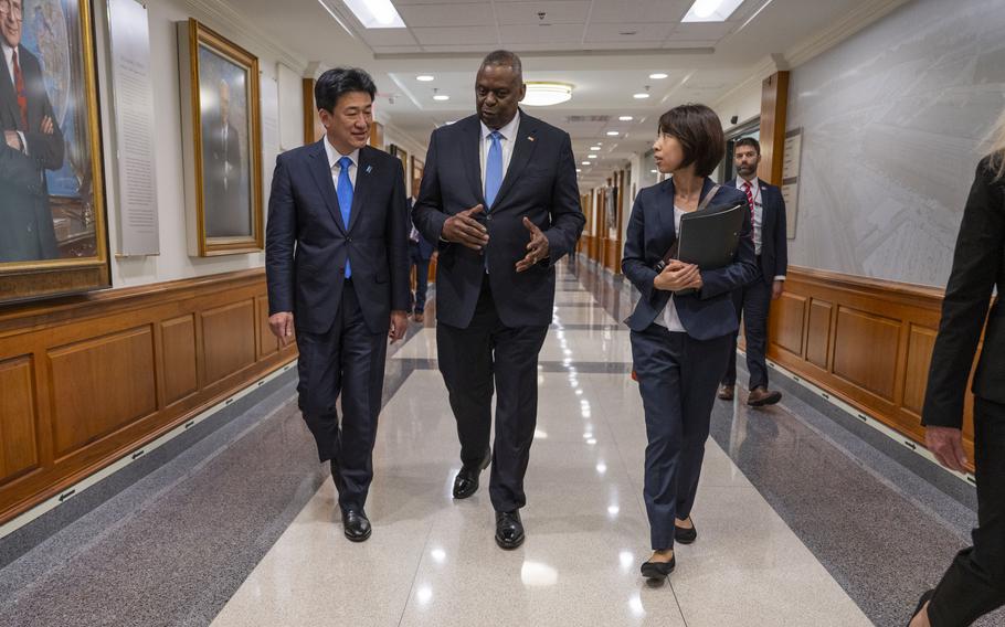 Defense Secretary Lloyd Austin walks with Japan’s Defense Minister Minoru Kihara at the Pentagon in October 2023. 