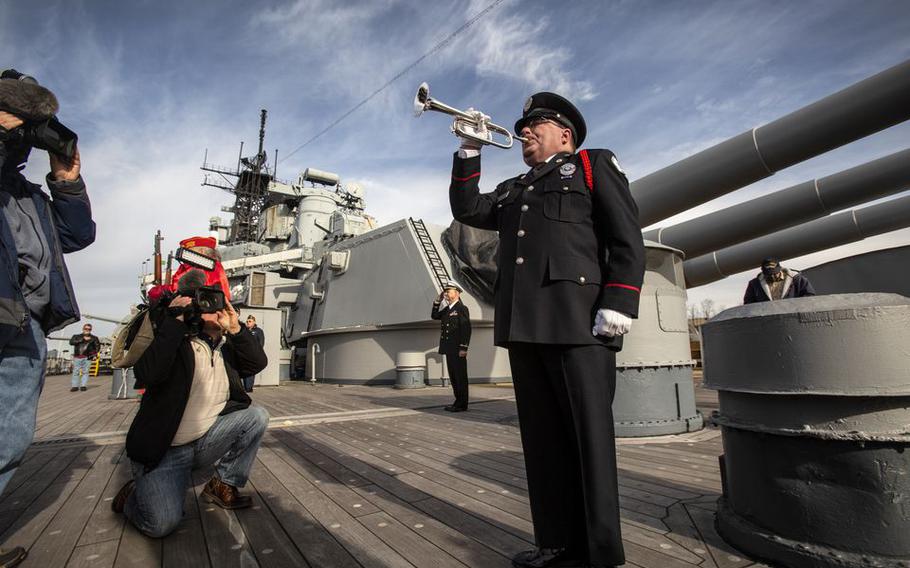 Bugler Greg Murphy, of Eriel, a member of Bugles Across America, plays taps on board the Battleship New Jersey during a Pearl Harbor Day Commemoration ceremony.