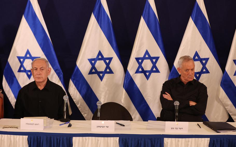 Israeli Prime Minister Benjamin Netanyahu, left, and Cabinet Minister Benny Gantz attend a press conference in the Kirya military base in Tel Aviv on Oct. 28, 2023, amid ongoing battles between Israel and the Palestinian group Hamas.