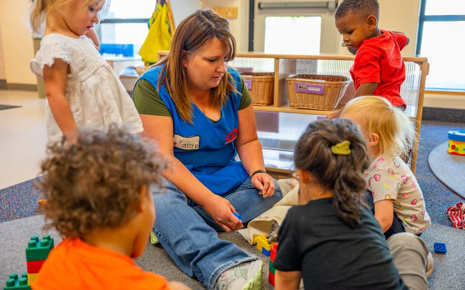 A group of children play with a Child Development Center staffer at Malmstrom Air Force Base, Mont., Sept. 8, 2022. In areas with limited availability of community child care facilities, such as Montana, on-base CDCs are an essential service for military families. 