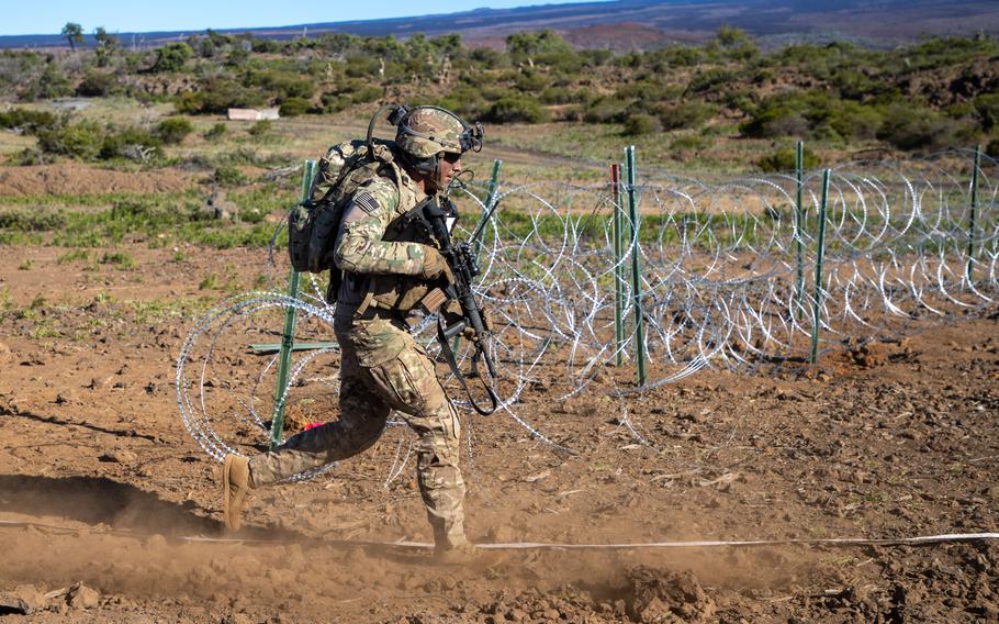 A soldier with the 3rd Infantry Brigade Combat Team, 25th Infantry Division, sprints on Pohakuloa Training Area June 4, 2021, during a fire support coordination exercise with Apache attack helicopters.