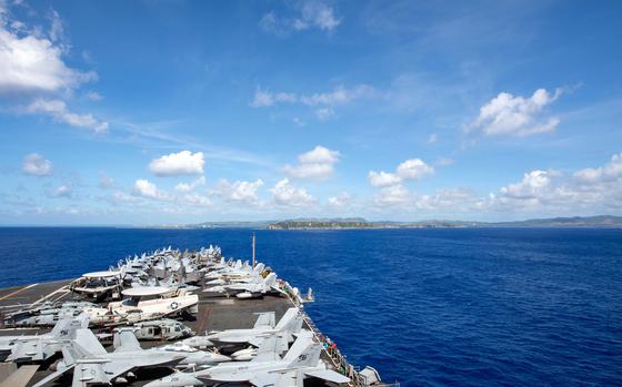 The aircraft carrier USS Carl Vinson approaches Naval Base Guam, March 24, 2025.