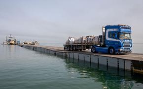 A truck carries humanitarian aid across the U.S.-built temporary pier off Gaza on May 19, 2024.