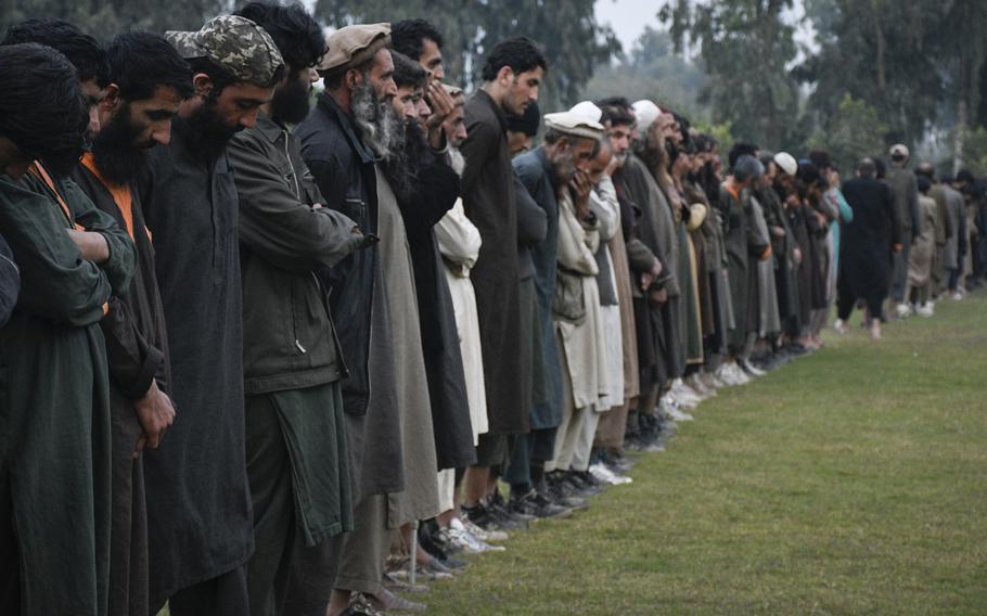 Islamic State fighters line up in Jalalabad, Afghanistan, in 2019 after surrendering to the Afghan government. In a criminal complaint filed Oct. 17, 2022, federal prosecutors accused a man hired by the U.S. military to be a translator in Afghanistan of lying about his contacts with the Islamic State terrorist group. 