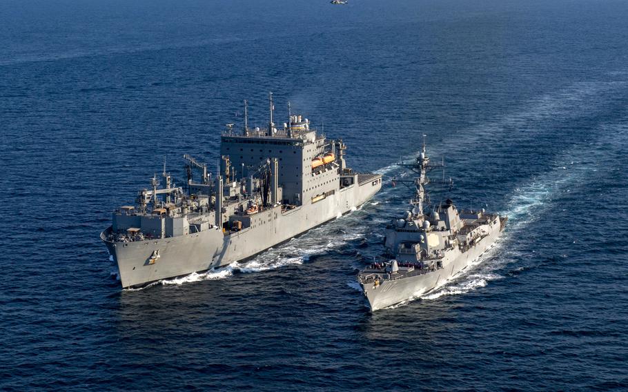 The dry cargo ship USNS Alan Shepard and the destroyer USS Gravely conduct a replenishment at sea in the Persian Gulf on Dec. 8, 2023. The Navy blamed the grounding of the Alan Shepard in Bahrain on July 15, 2023, on the absence of the ship’s master from the bridge at a key moment.