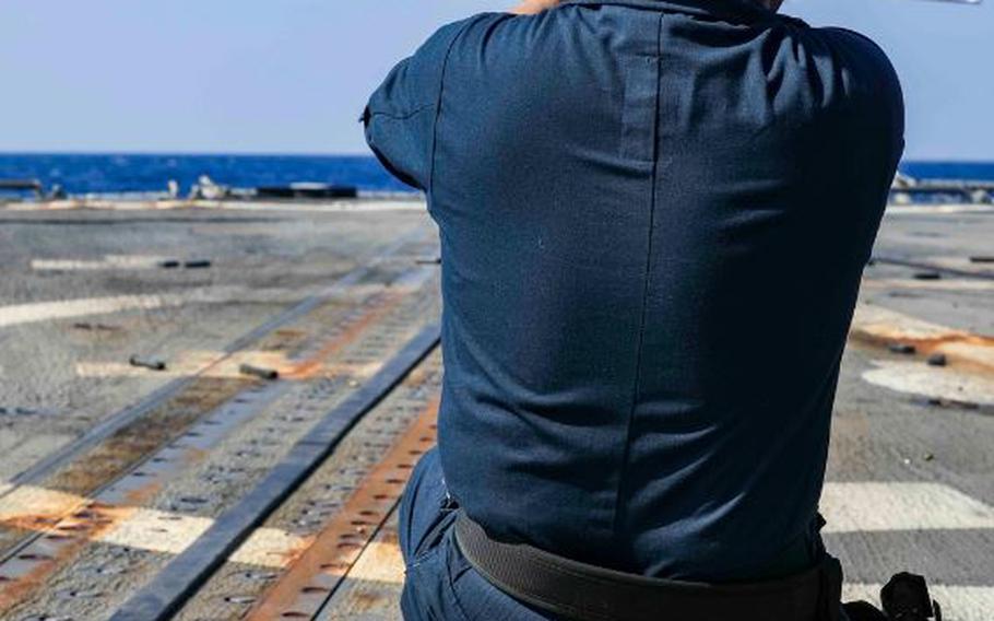 Fire Controlman 1st Class Ronnel Marasigan, from Dededo, Guam, participates in a small arms qualification course on the flight deck aboard the Arleigh Burke-class guided-missile destroyer USS Shoup (DDG 86) while conducting routine operations in the Philippine Sea, Oct. 28.