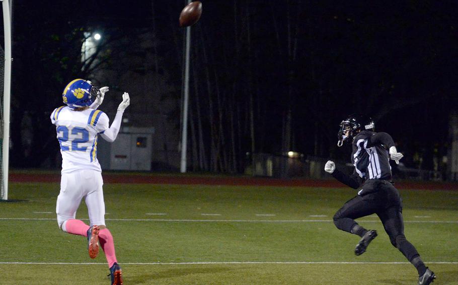 Yokota's Damian Abrams hauls in a touchdown pass ahead of Zama defender Pierce Ingram.