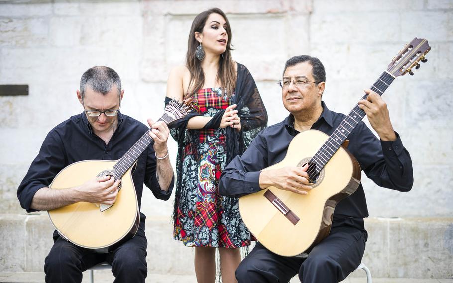 A fado band performs the traditional sounds of the melancholy style  on the square of the Alfama neighborhood in Lisbon, Portugal.