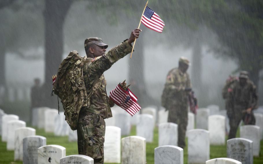 Soldiers from the 3rd U.S. Infantry Regiment (The Old Guard) place flags at headstones as part of Flags-In at Arlington National Cemetery in 2019. A Rand Corp. report that examined life outcomes for vets found that Black veterans enjoy a higher standard of living than African Americans who never served.
