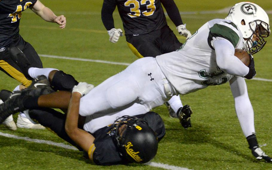 Kubasaki's T.J. Reese is brought down short of the goal line by Kadena's Kai Christy, on a pass play that set up the Dragons' lone touchdown.