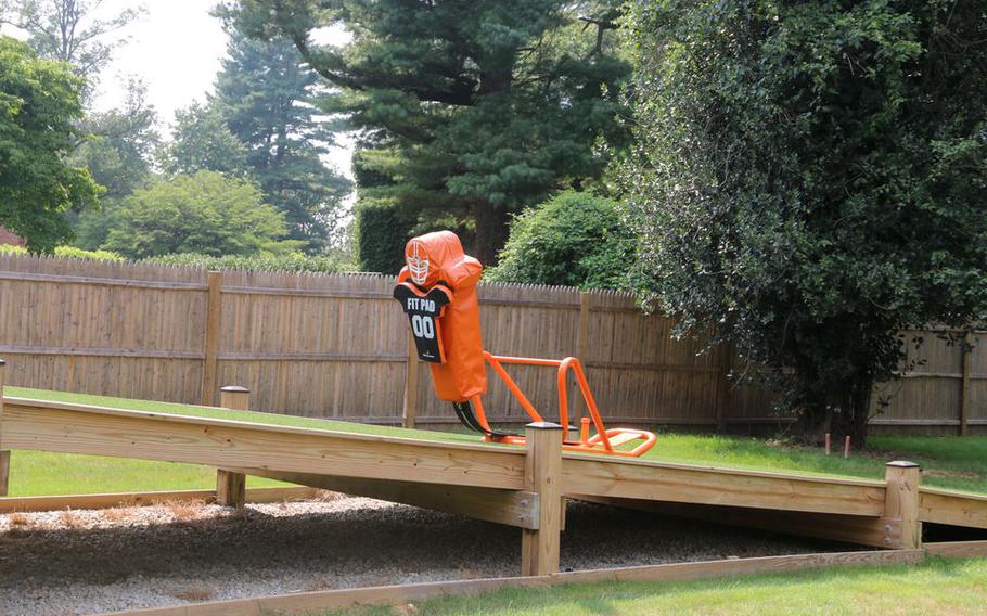 A blocking sled sits on a ramp behind "The Bro Barn"