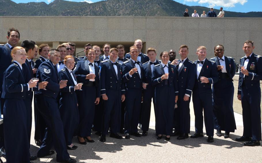 Newly commissioned second lieutenants from Cadet Squadron 14 at the U.S. Air Force Academy in Colorado Springs, Colo., drink a toast with leadership at their commissioning ceremony on May 25, 2021. Tanner Johnson, third from right, is the first person diagnosed with Type 1 diabetes to commission into the U.S. military.