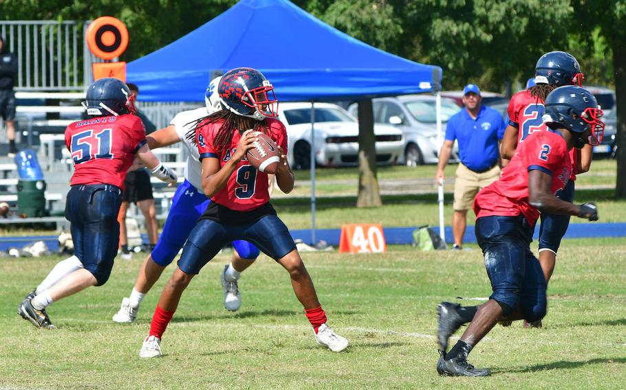 Aviano's Adrew Walker drops back to throw a pass in the Saints' 44-0 victory over the Admirals on Saturday, Sept. 23, 2023.