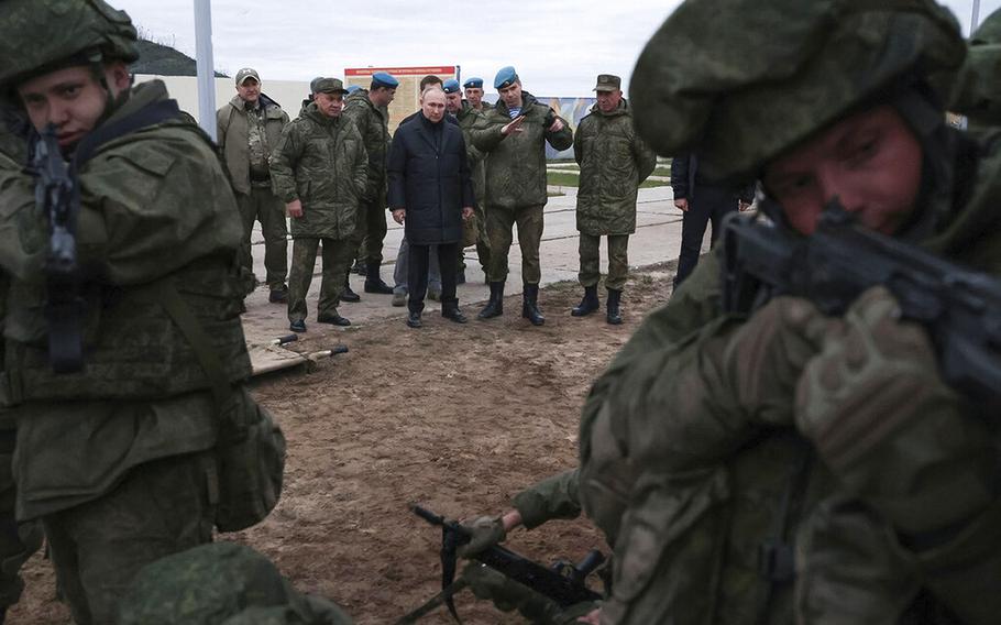 Russian President Vladimir Putin, center, and other officials visit a military training center of the Western Military District for mobilized reservists in Ryazan Region, Russia, on Oct. 20, 2022. 