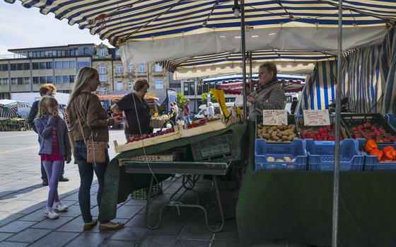 Shoppers peruse offerings at a weekly farmers market Aug. 8, 2023, in Kaiserslautern, Germany. Despite price increases across Germany, U.S. service members in the Kaiserslautern Military Community will see their overseas cost of living allowances drop starting with next month's paychecks.