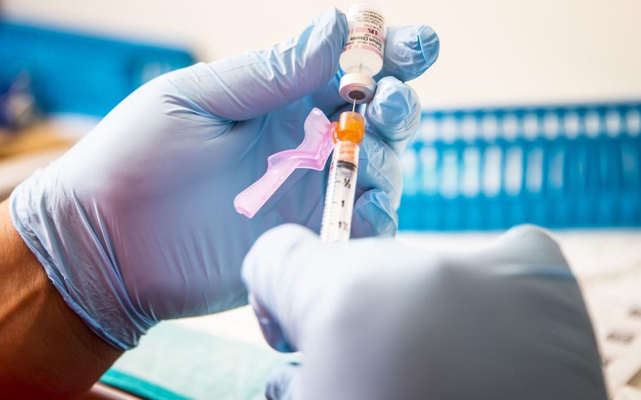 A health care worker prepares a vaccine in Boston on June 17, 2021. 