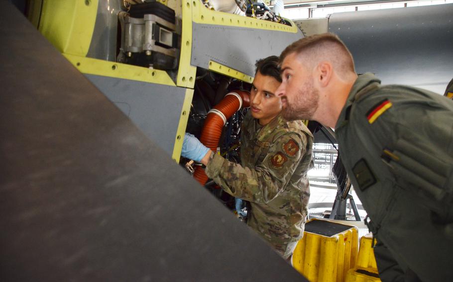 Airman 1st Class Samuel Alcala Perez, left, explains some of the workings of the C-130J to German military academy cadet Nicolas Polster on July 15, 2021, at Ramstein Air Base. Polster and six other future Luftwaffe pilots spent two weeks at Ramstein Air Base working alongside maintainers to learn what it takes to prepare aircraft for flight.