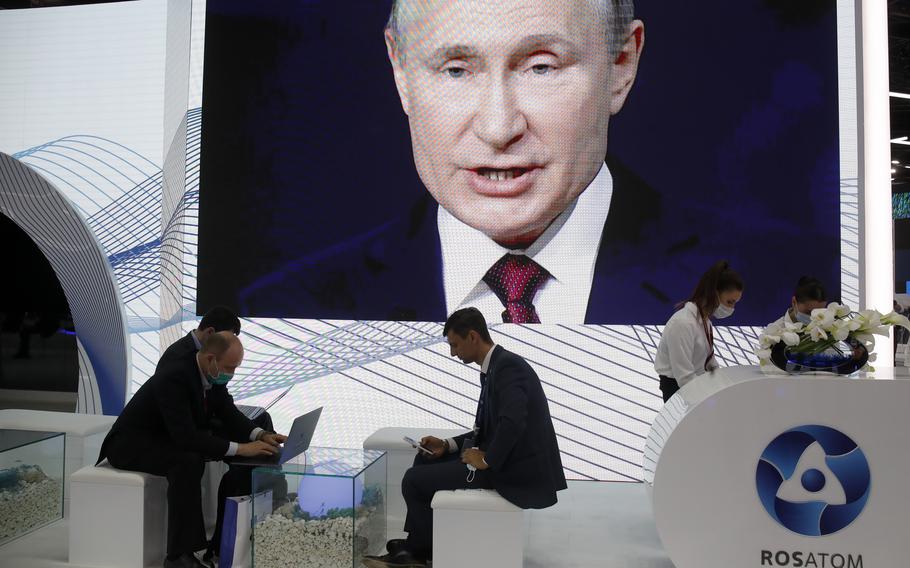 People work in the press center as they listen to Russian President Vladimir Putin speak at the St. Petersburg International Economic Forum in St. Petersburg, Russia, on Friday, June 4, 2021.