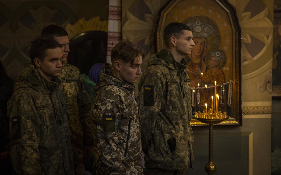 Fellow service members gather Wednesday at the St. Feodosiivsky Monastery in Kyiv for the funeral of 128th Mountain Assault Brigade soldier Mykyta Vlaskov.