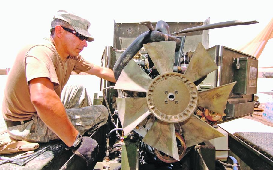 Sgt. Victor Rascon, 36, from San Diego, deployed with the Company B, 29th Signal Battalion motor pool rebuilds a 15k generator, "I'll probably finish it tomorrow," to complete it within the 38-hour turnaround on Wednesday afternoon on FOB Sykes. 